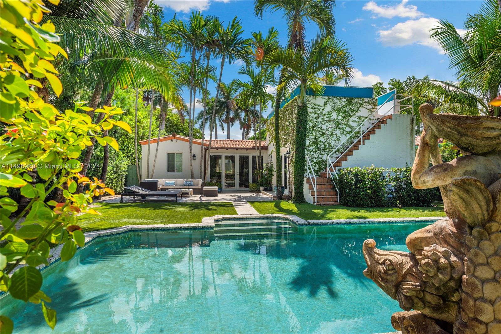 a view of a house with swimming pool and a garden