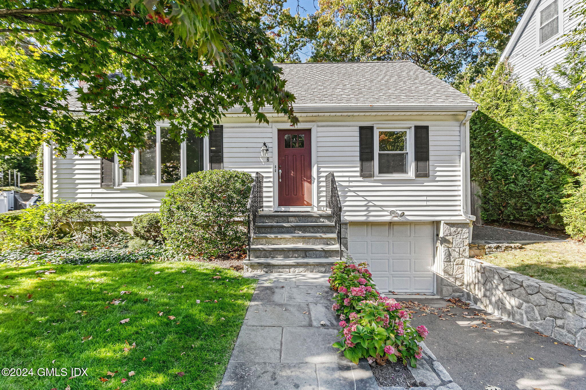 a front view of a house with garden