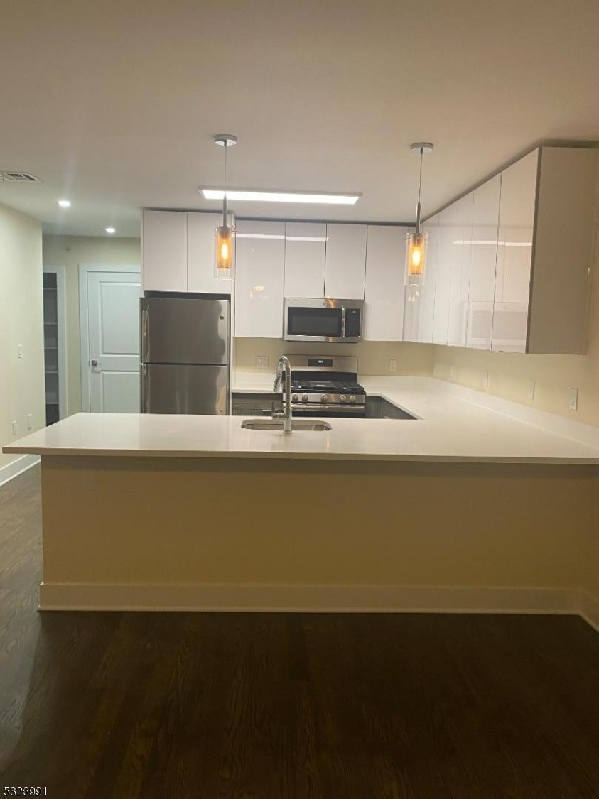 a view of kitchen with wooden floor