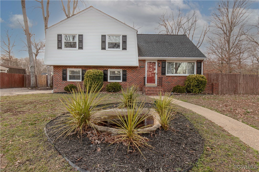 Split level home with a front lawn