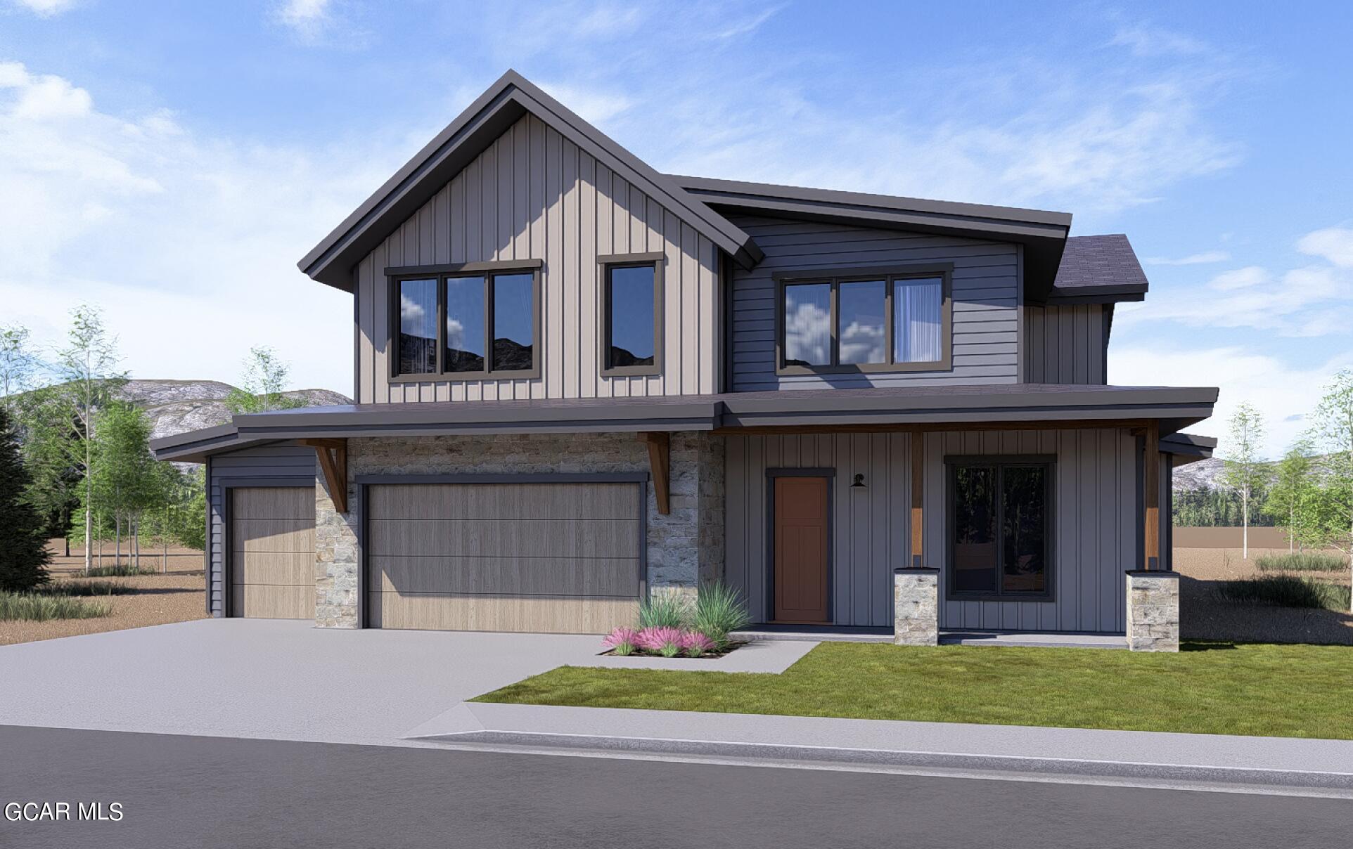 a front view of a house with a garden and garage