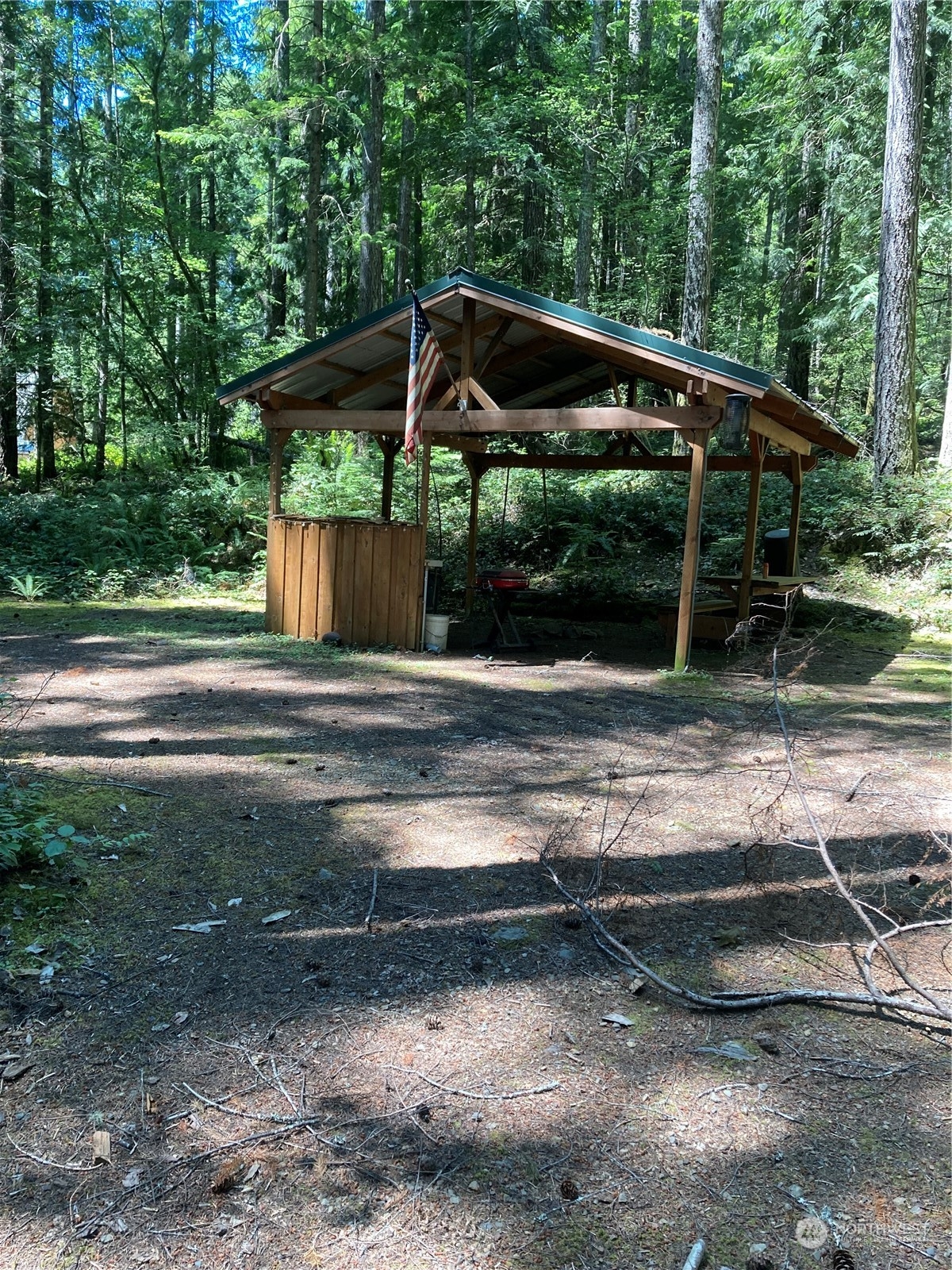 a view of backyard with wooden deck and trees