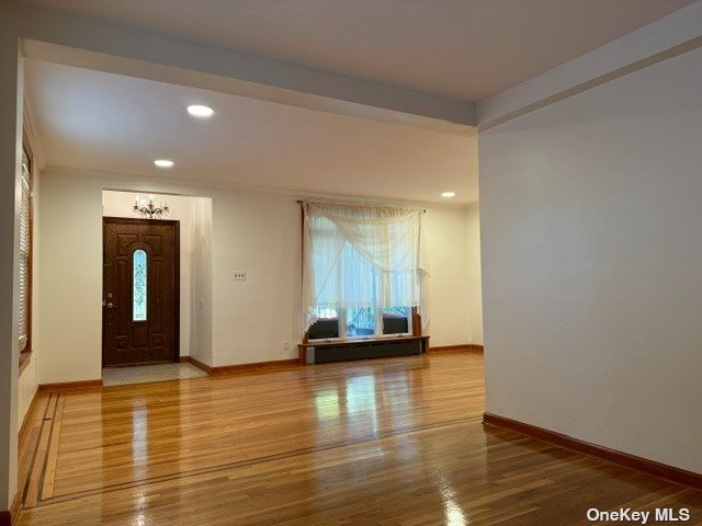 a view of a room with floor to ceiling window and wooden floor