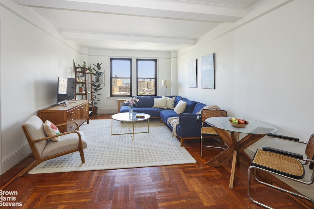 a living room with furniture and wooden floor