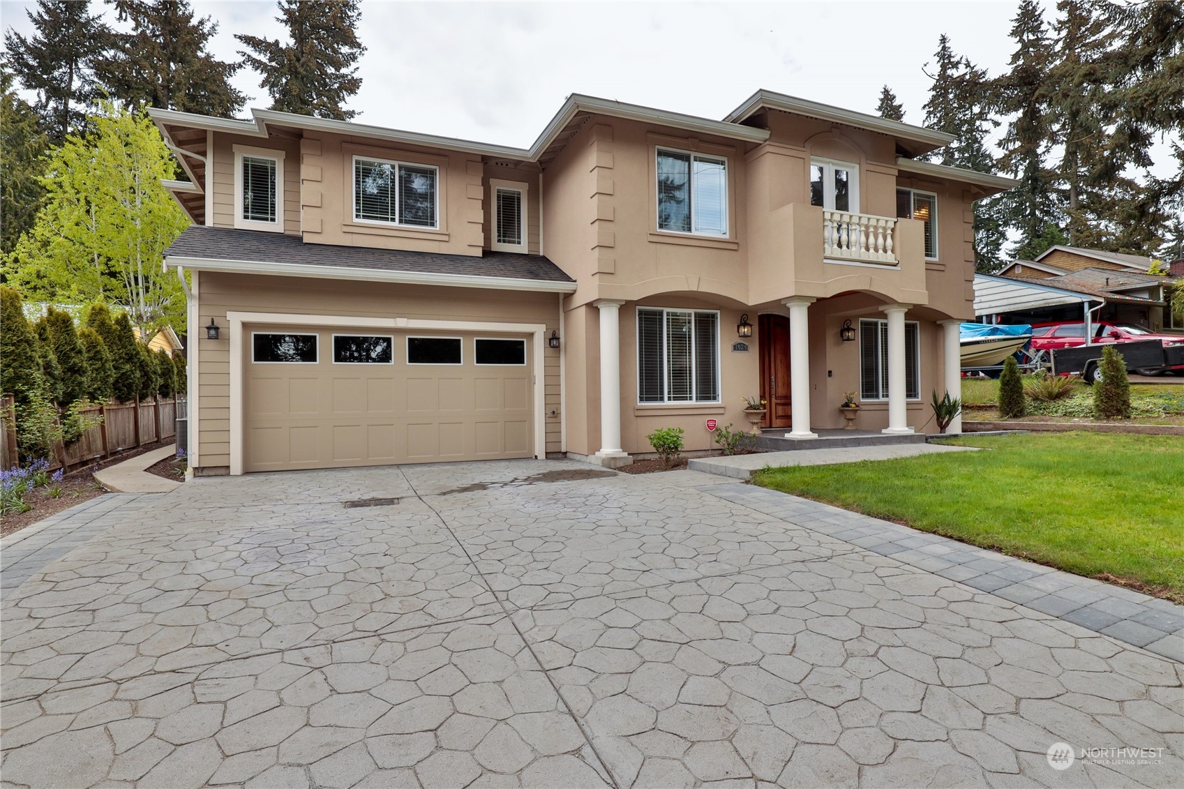 a front view of a house with a yard and garage