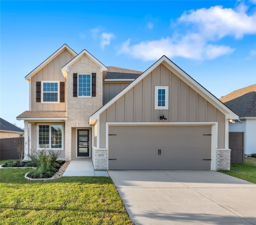 Craftsman-style home with a front yard and a garag