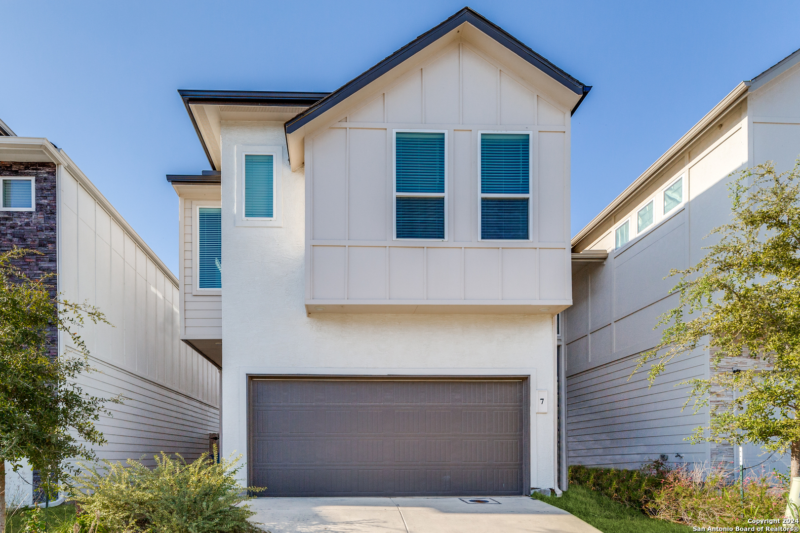 a front view of a house with garage