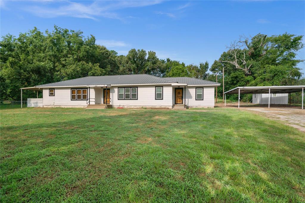 a view of a house with a backyard