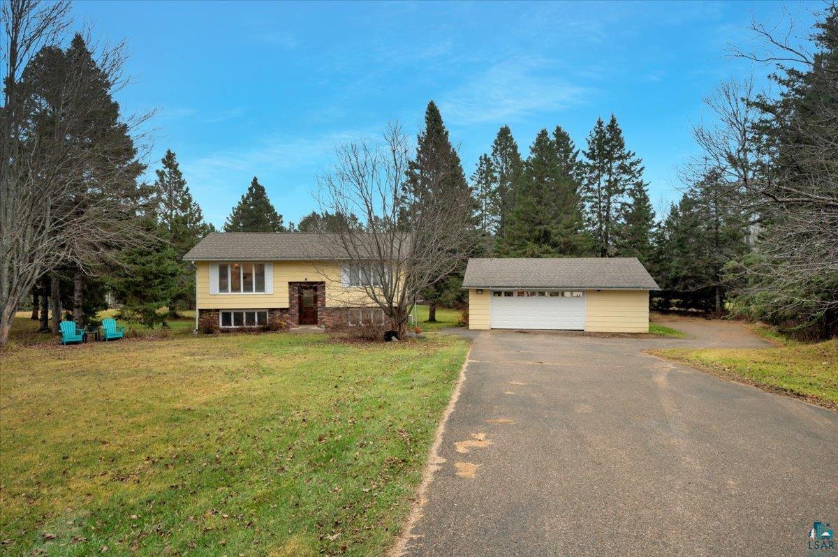 Front of house with a front yard and a garage