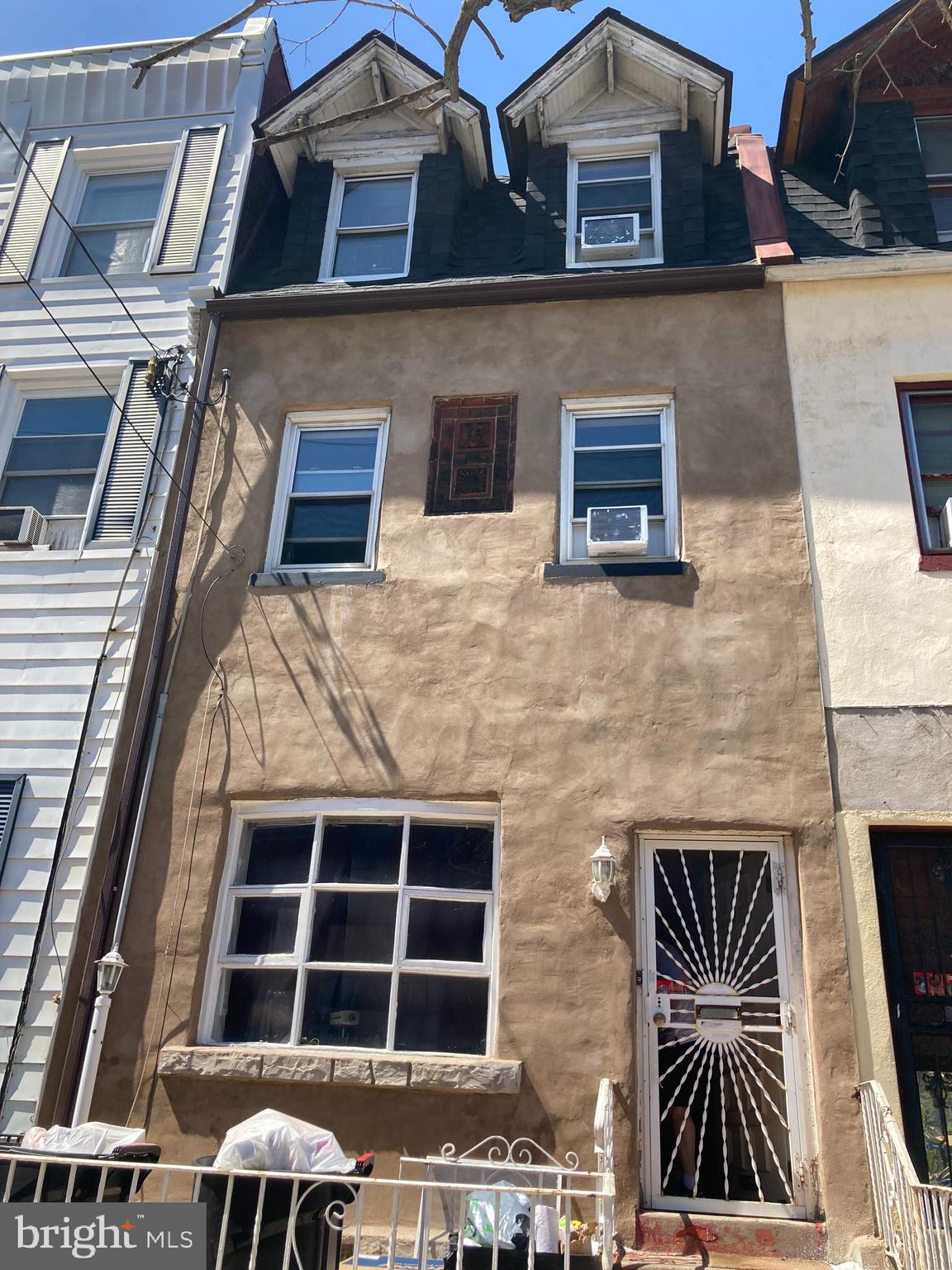 a front view of a house with large windows