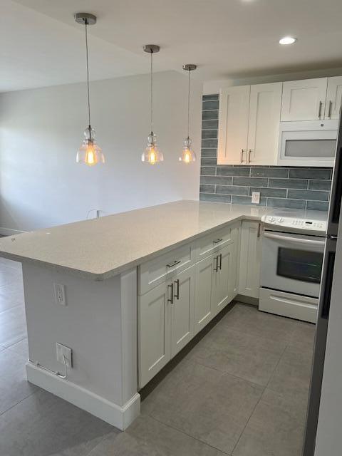 a kitchen with white cabinets appliances and a sink