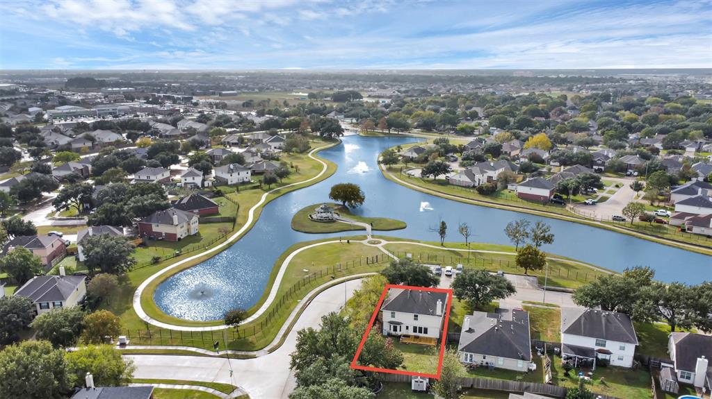 an aerial view of a house with a swimming pool outdoor seating and yard