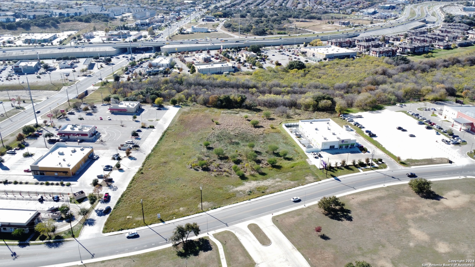 an aerial view of a residential houses with outdoor space