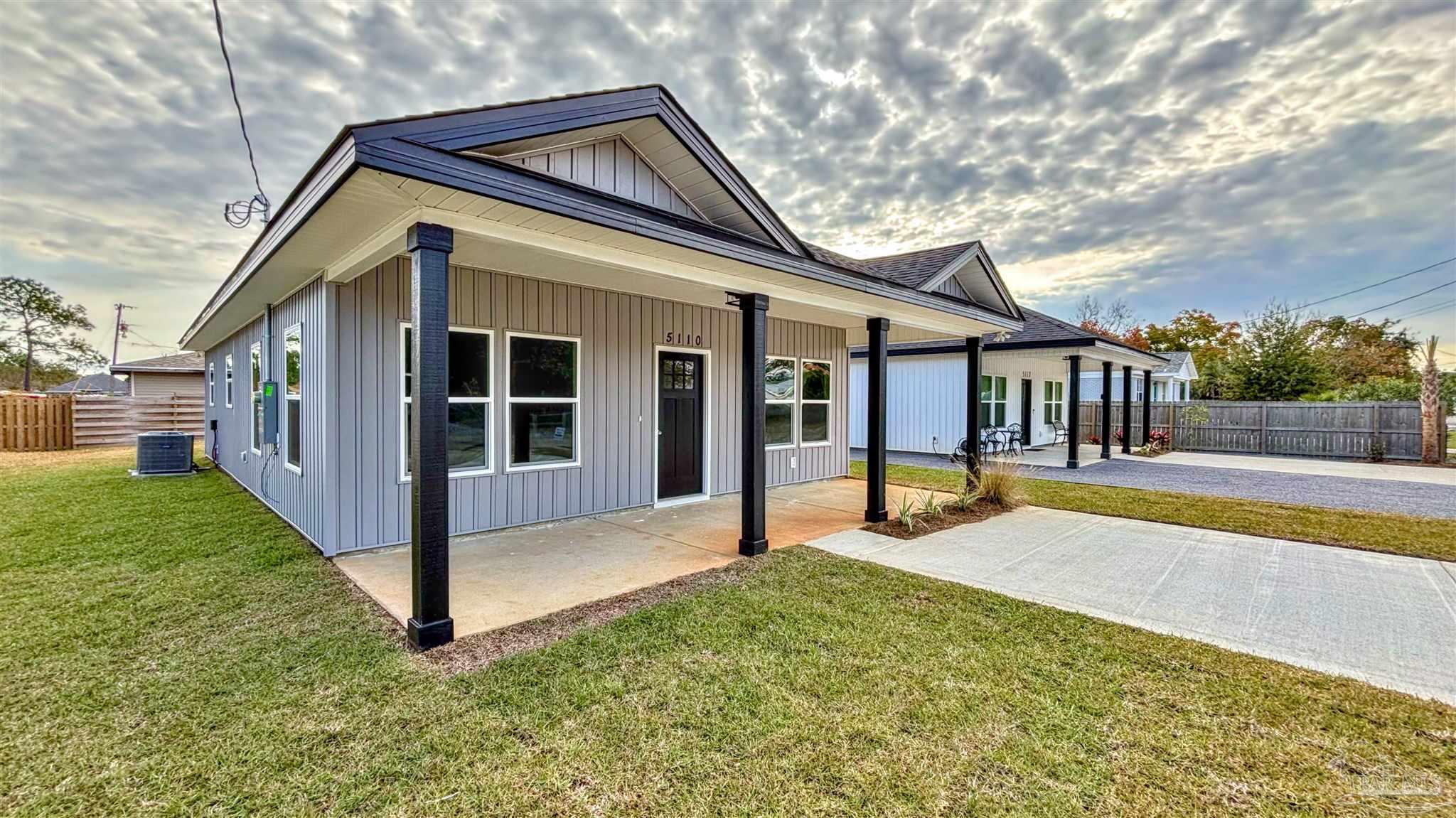 a view of a house with backyard and porch