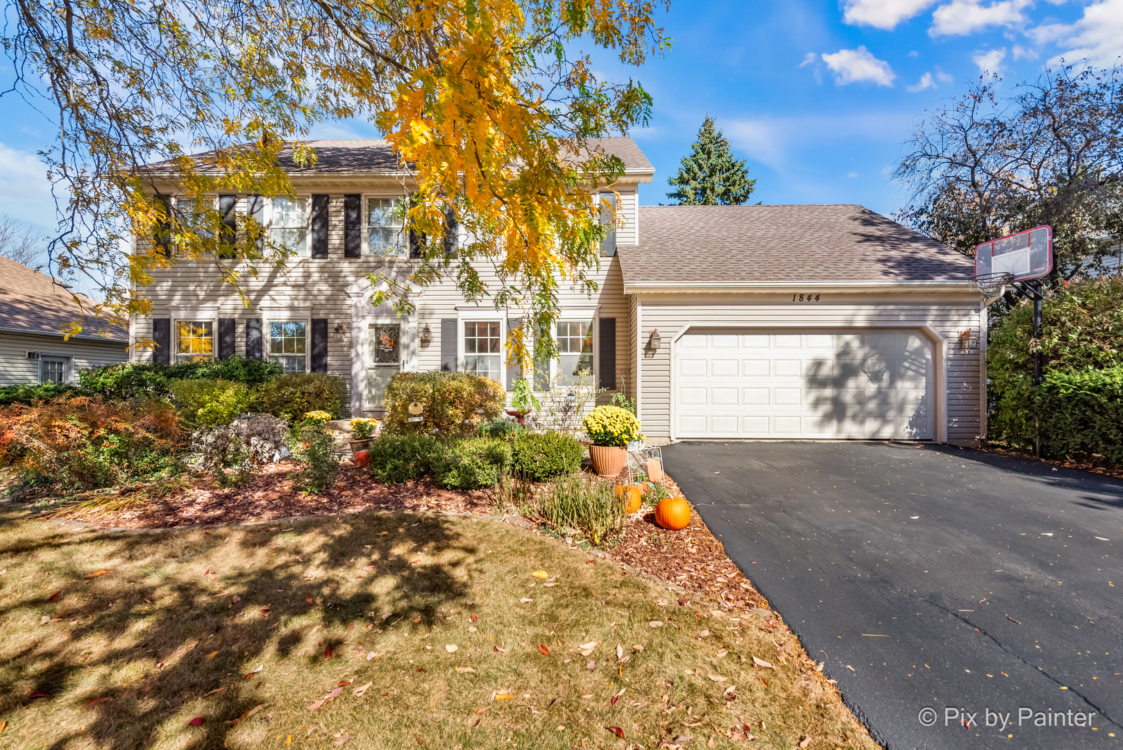 a front view of a house with a yard and garage