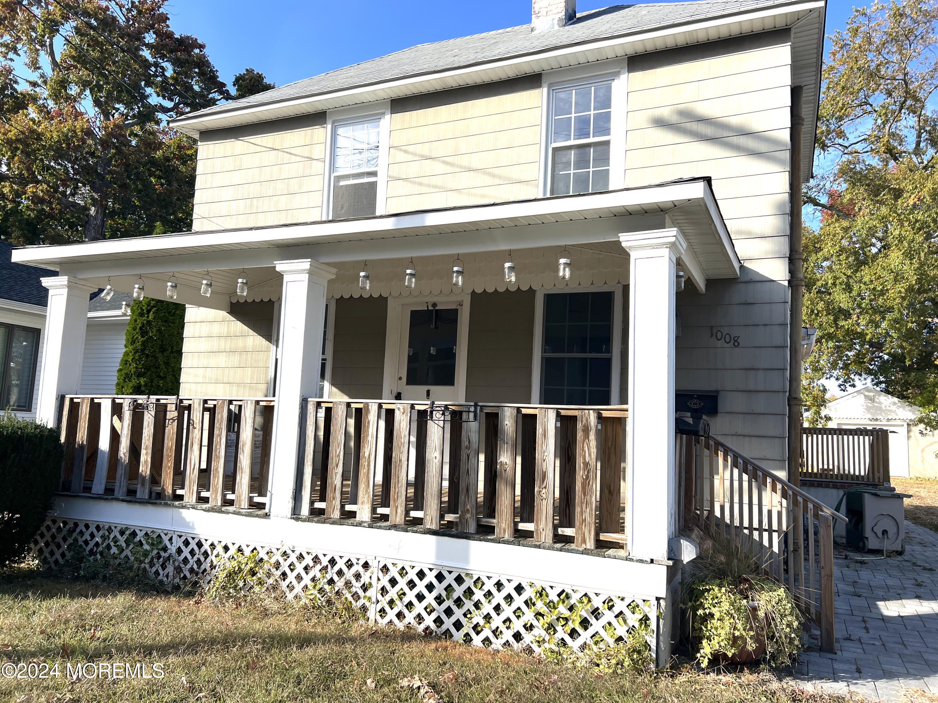 a view of a house with a wooden fence