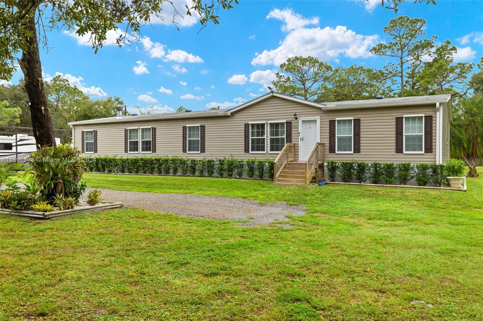 a front view of house with yard and green space