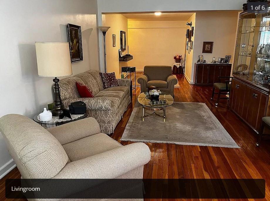 a living room with furniture rug and lamp