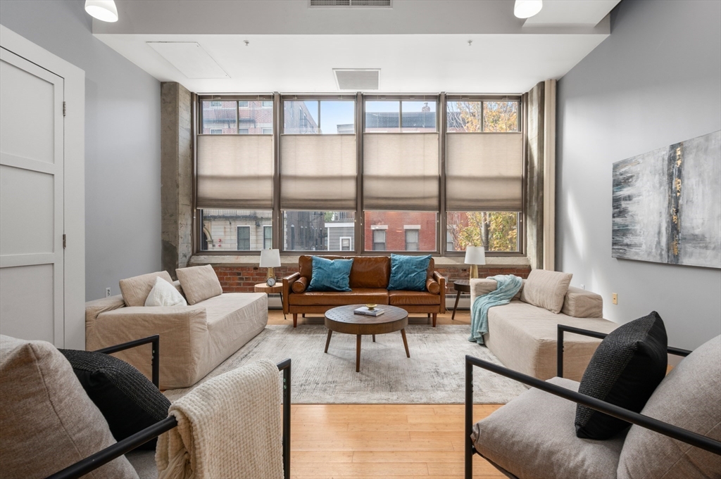 a living room with furniture and a large window