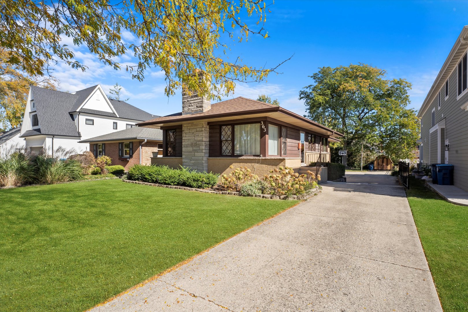 a front view of a house with a garden