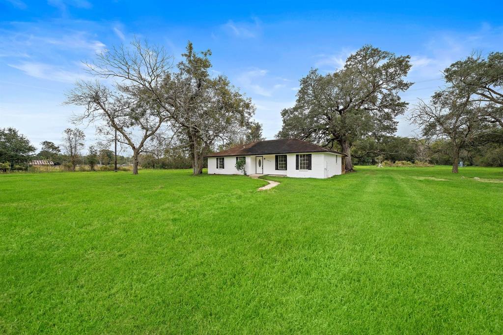 a house view with a sitting space and garden