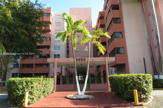 a front view of a building with garden