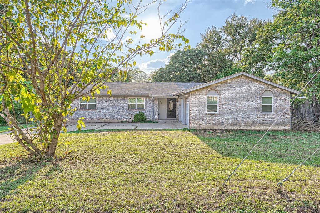 Ranch-style house featuring a front lawn and a patio