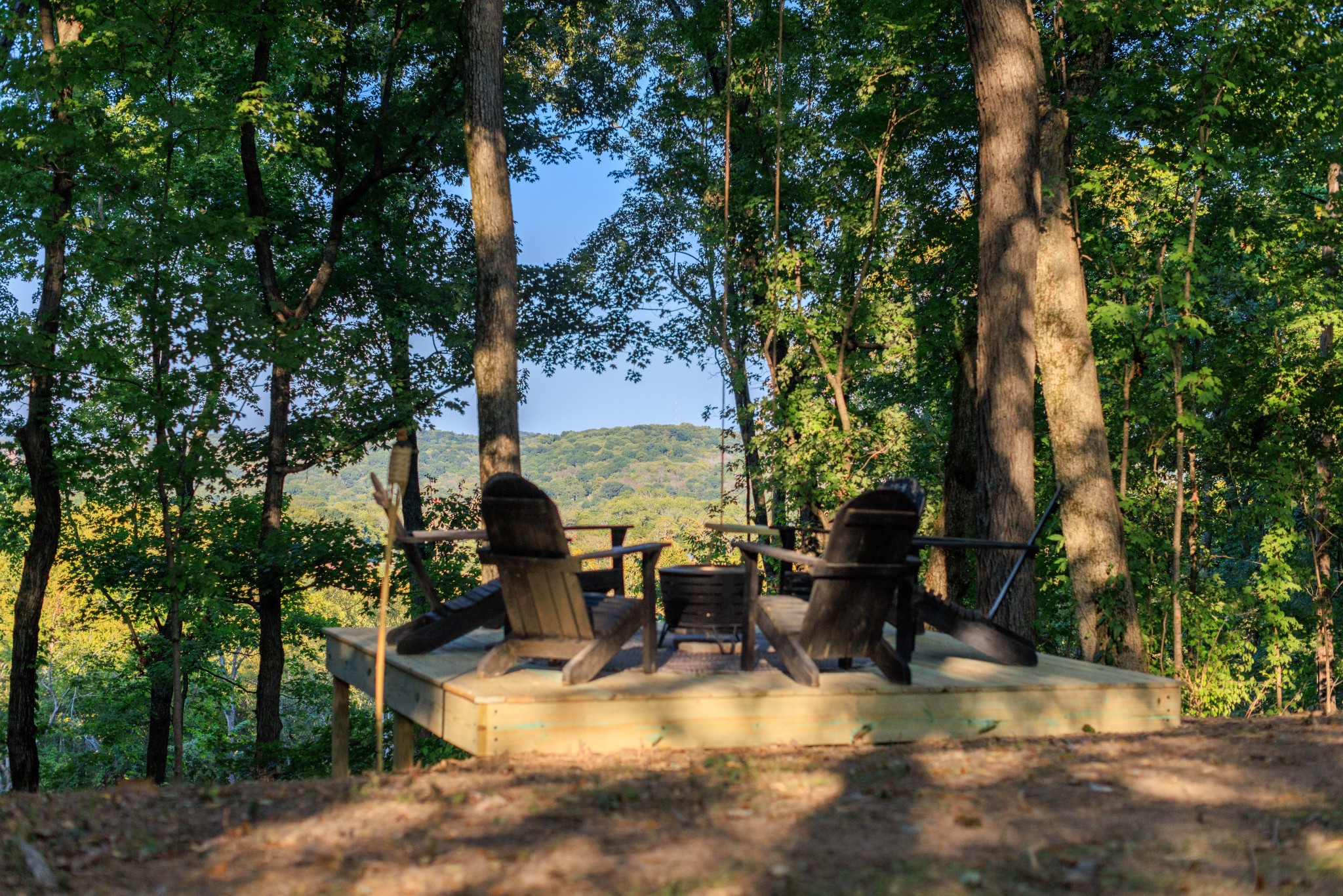 a view of outdoor space with seating area and trees around