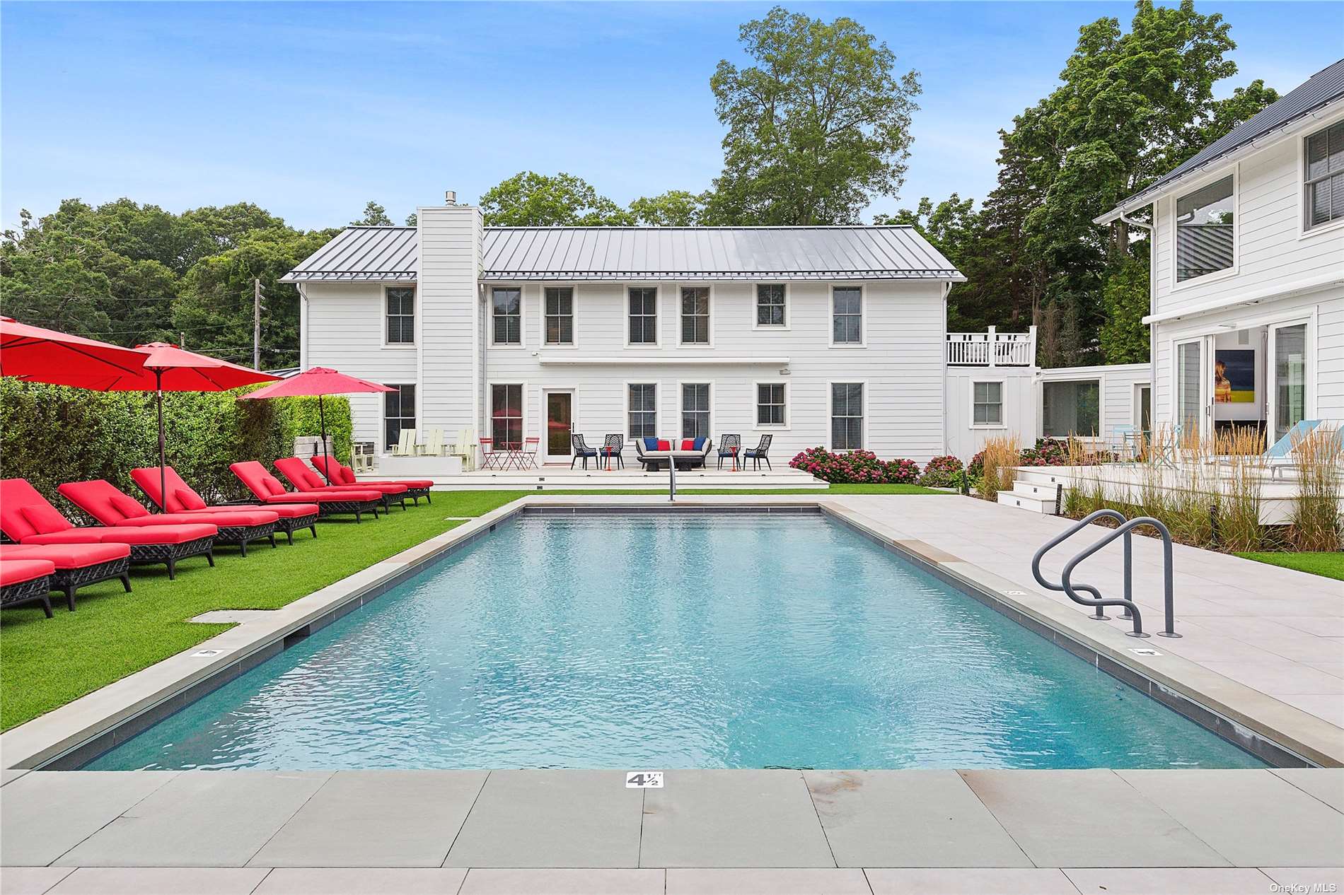 a swimming pool view with outdoor seating