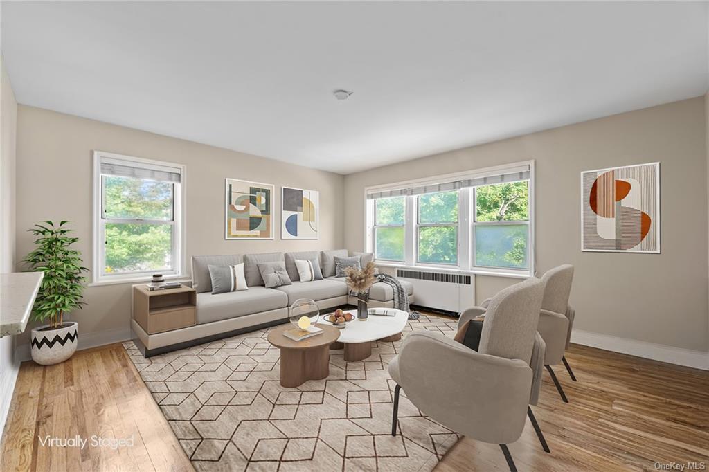 Living room with radiator and light hardwood / wood-style flooring