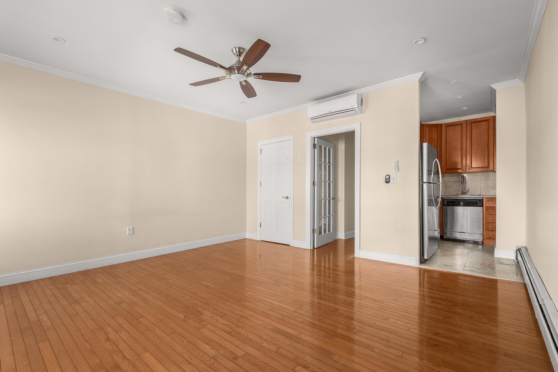 a view of a livingroom with a hardwood floor and a ceiling fan