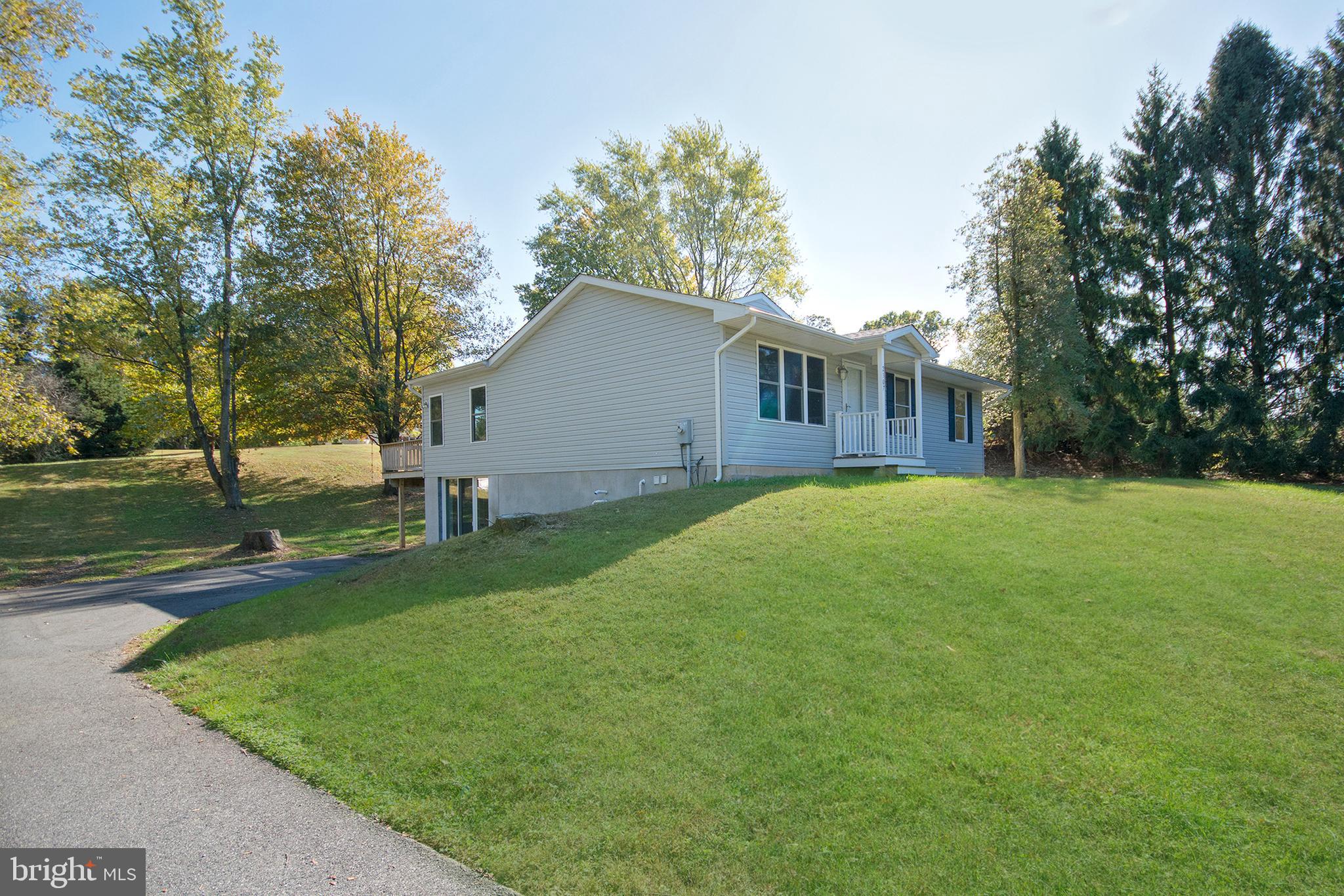 a view of backyard of house with green space