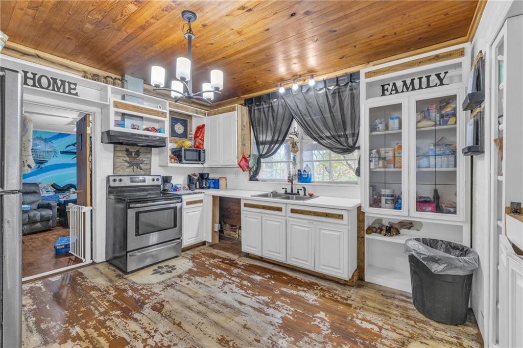 a kitchen that has a lot of cabinets in it