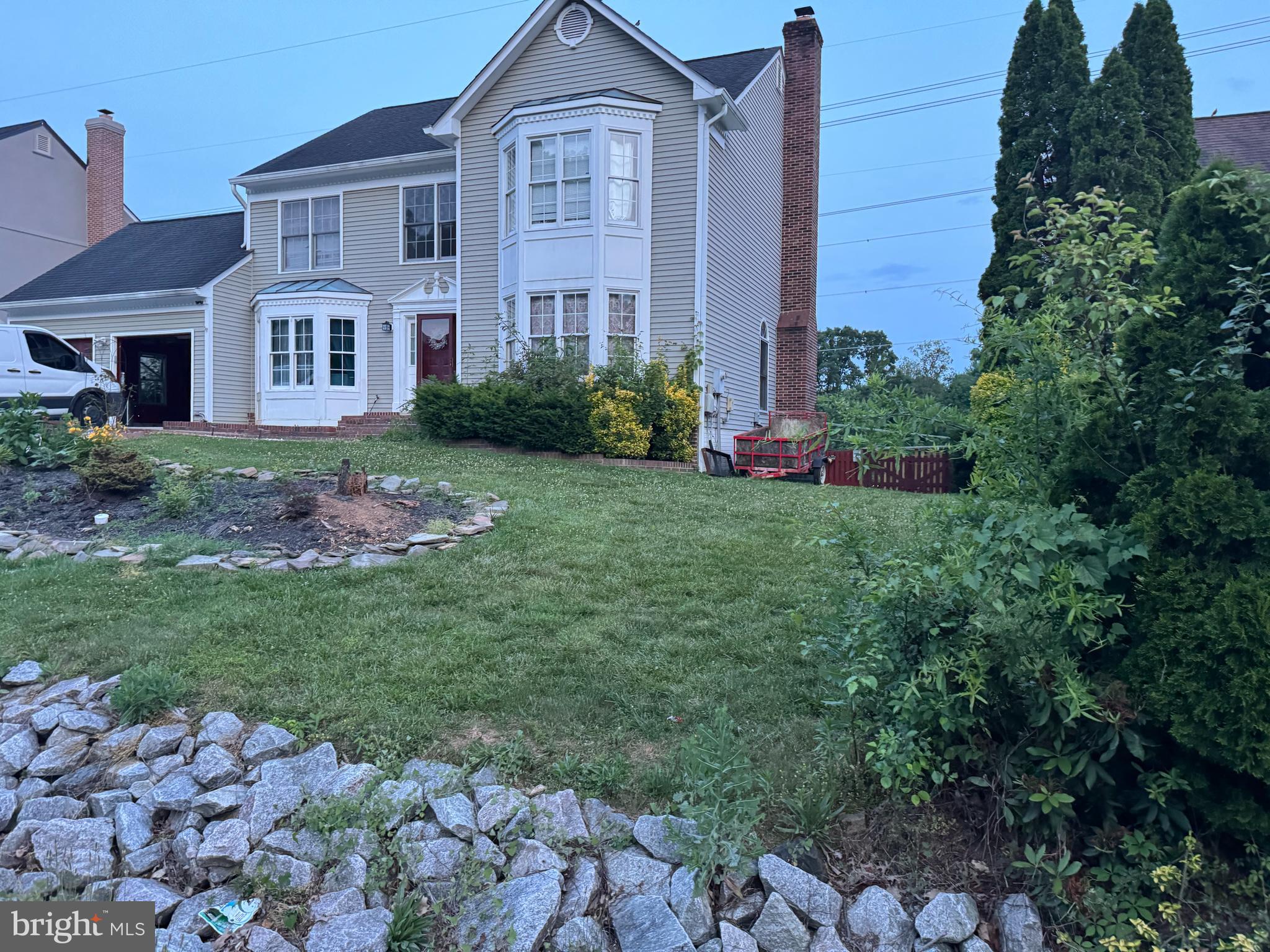 a front view of a house with a garden