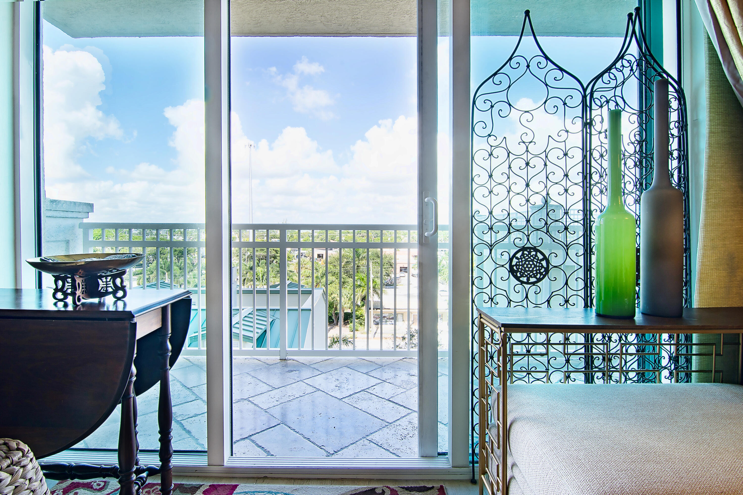 a view of a balcony with a table and chairs