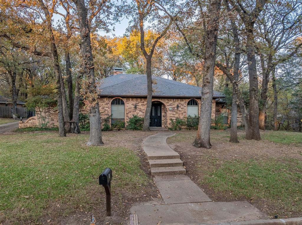 a view of a house with backyard and a tree