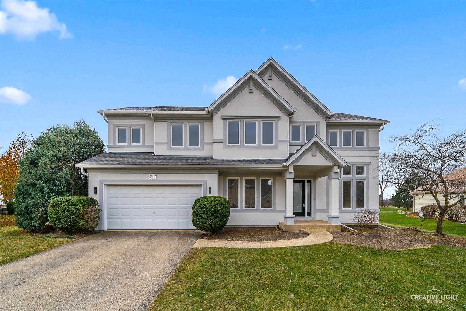 a front view of a house with a yard