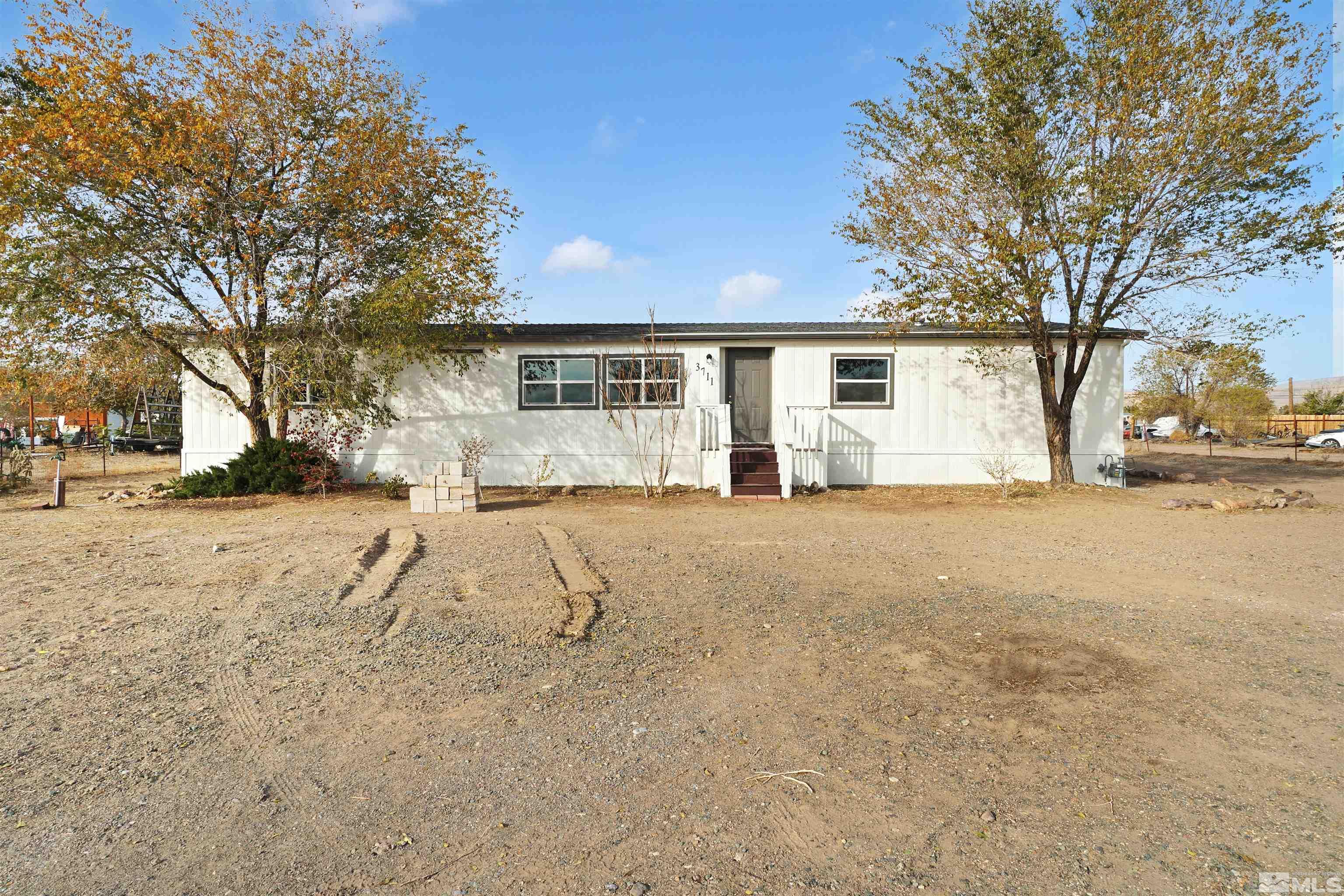 a view of the house with a yard