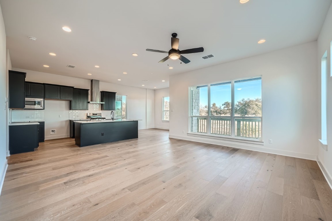 a view of kitchen with microwave and refrigerator