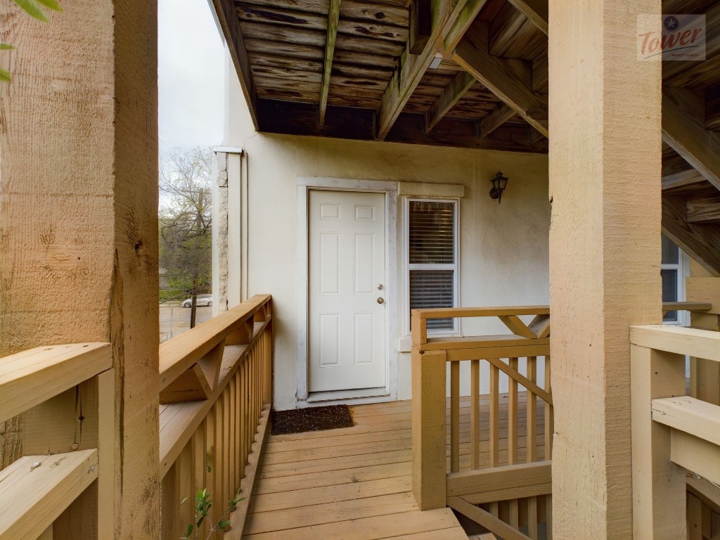 a view of an entryway with wooden floor and door