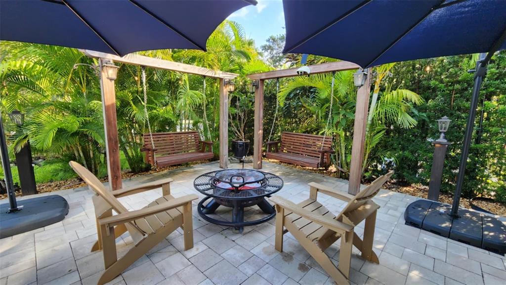 a view of a patio with a table chairs and a umbrella