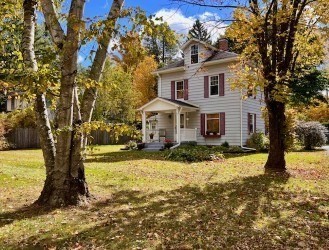 a front view of a house with a yard