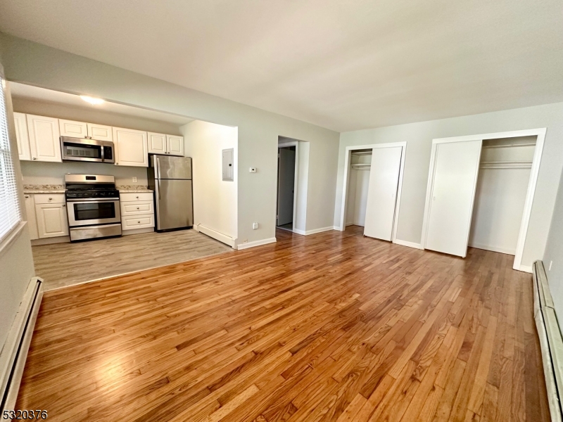 a view of a kitchen with wooden floor