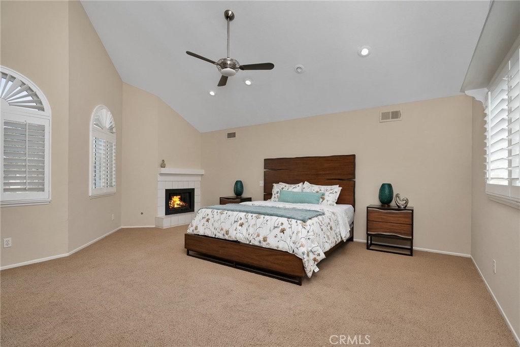 a spacious bedroom with a bed and a chandelier