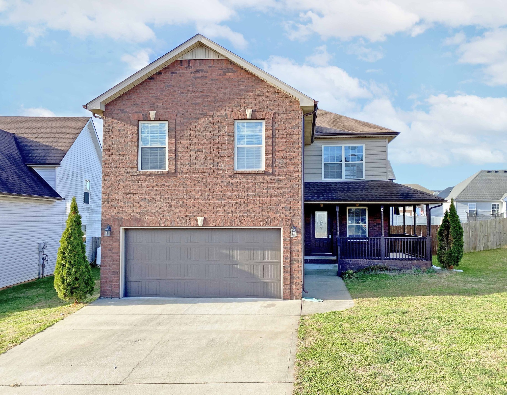 a front view of a house with yard and garage