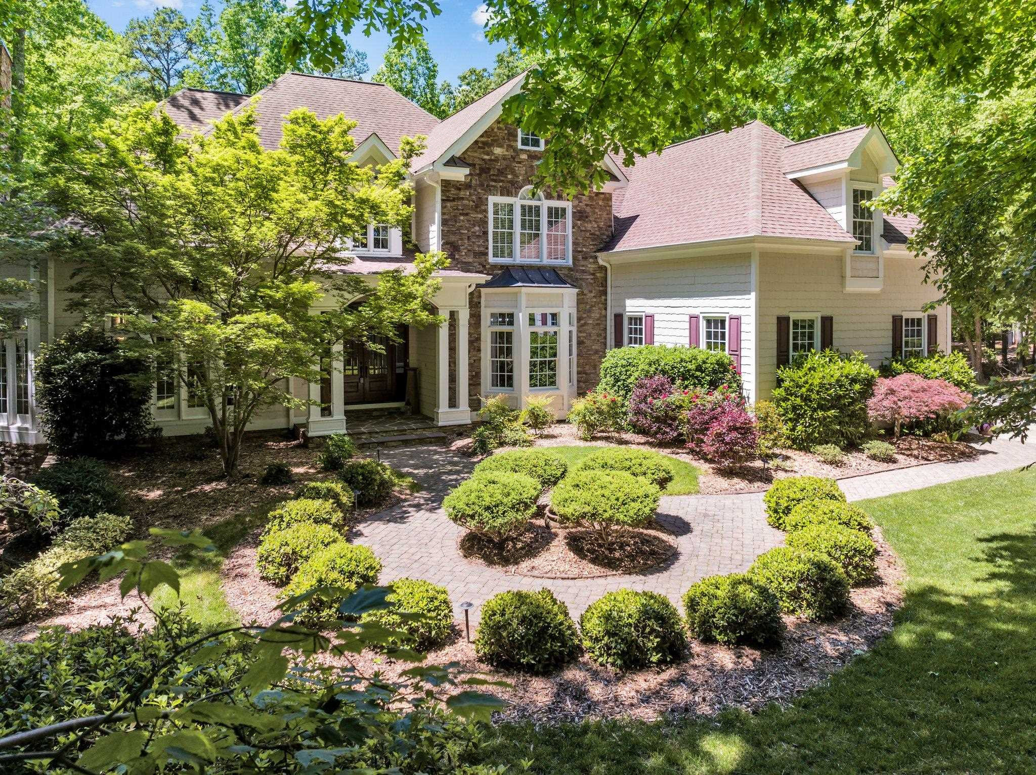 a front view of a house with a yard and outdoor seating