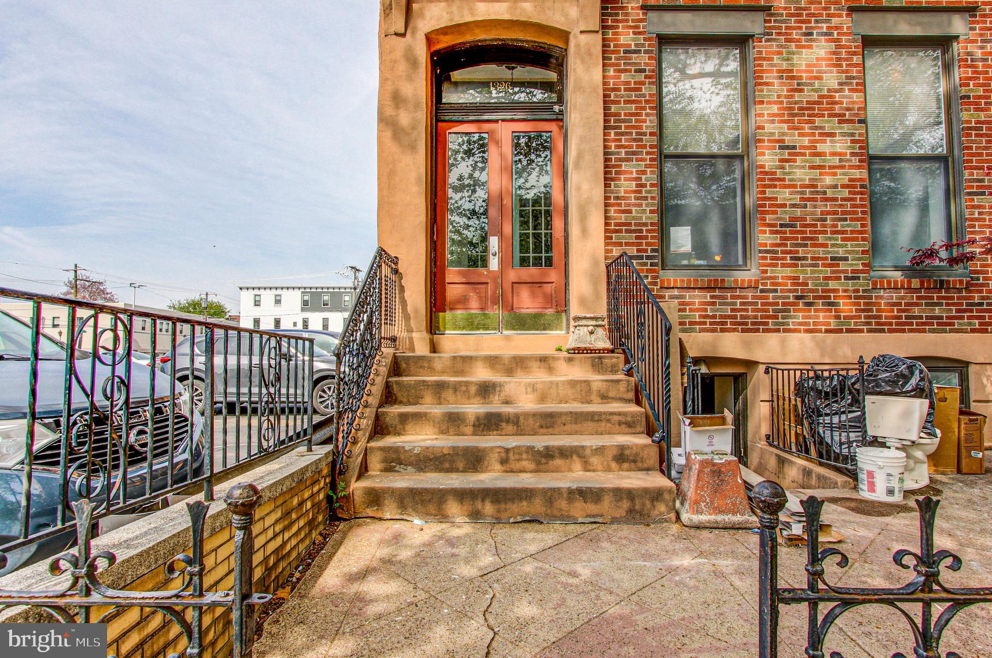 a view of a brick house with large windows