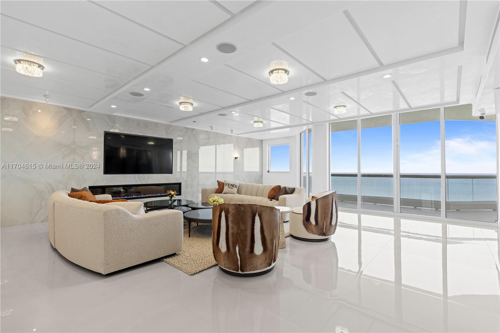 a living room with furniture a flat screen tv and a large window