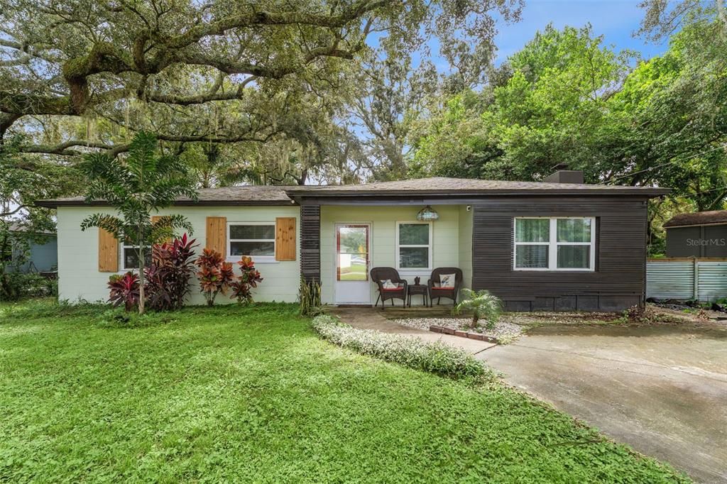 a front view of house with outdoor seating and yard