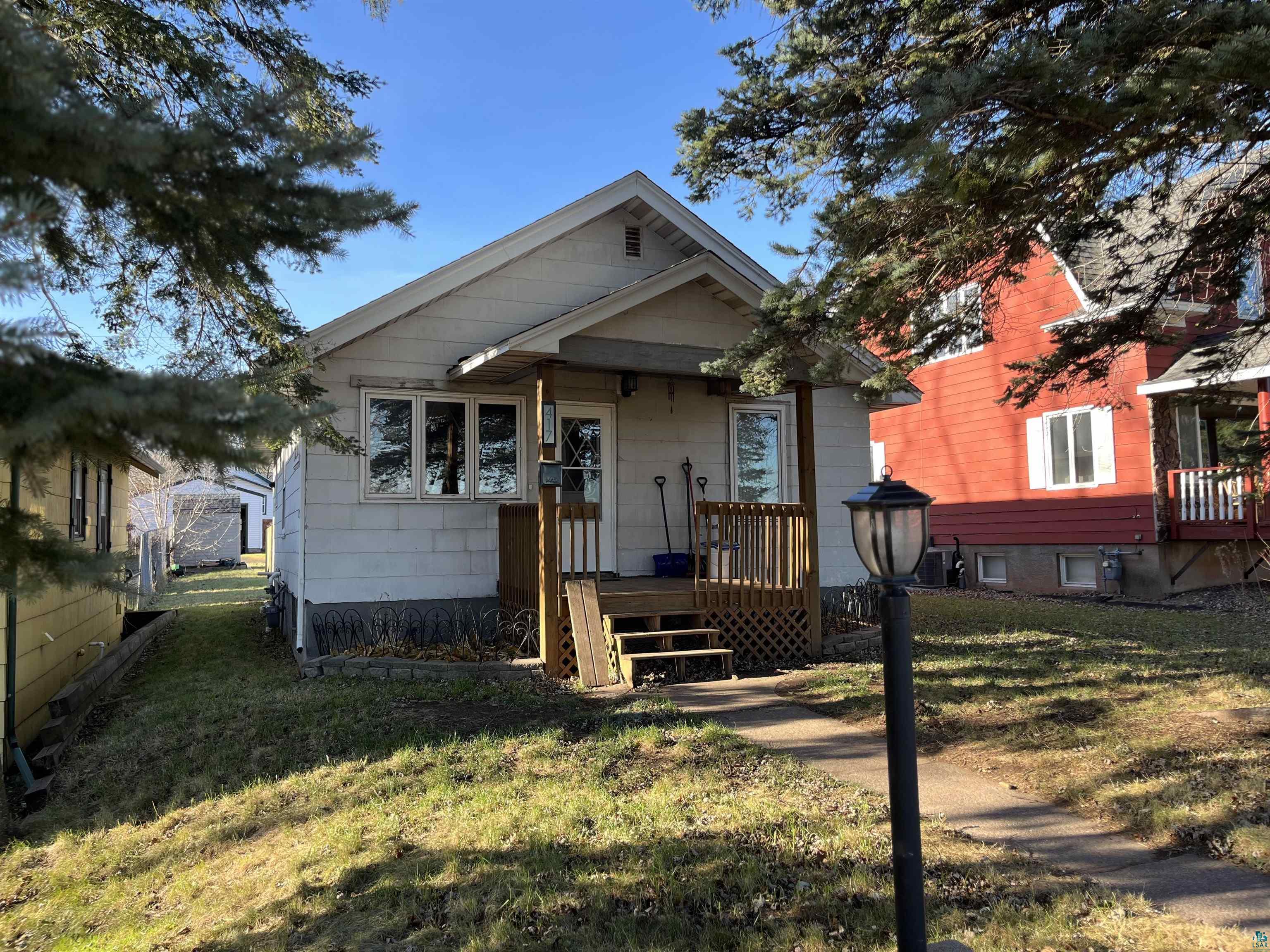 Bungalow-style house with a front yard